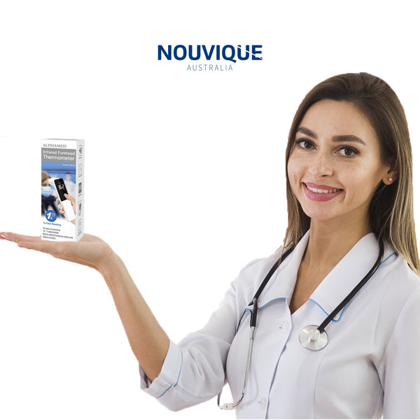 Nurse with stethoscope around neck holding up a Nouvique Australia Digital Thermometer (in packaging box) on the palm of her hand.
